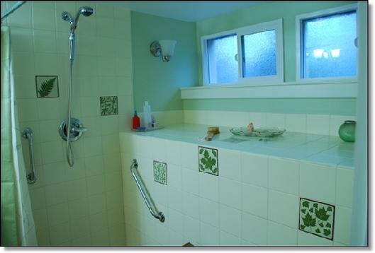 HAND PAINTED BOTANICAL TILES WITH READILY AVAILABLE FIELD TILES MAKE AN EXQUISITE BATHROOM SHOWER INSTALLATION